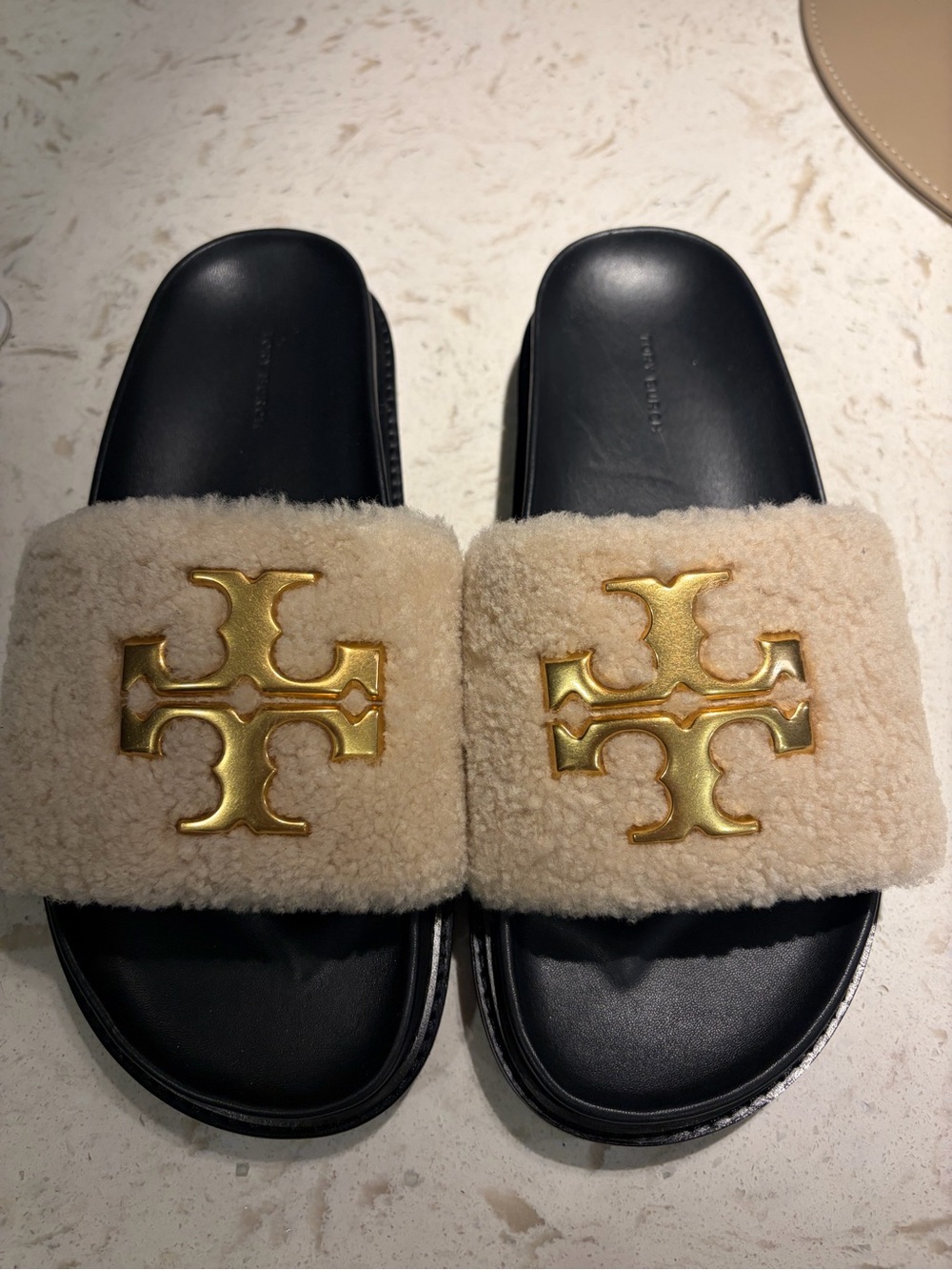 Tory Burch Cream Shearling Slides with Gold Logo on Black Footbed